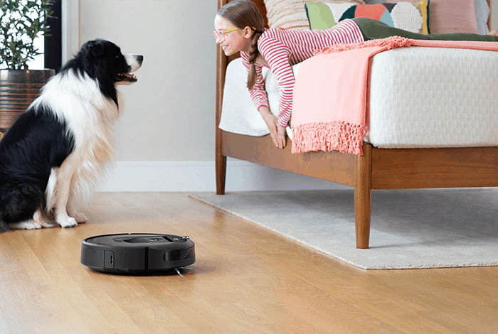 iRobot roomba with a dog and a girl
